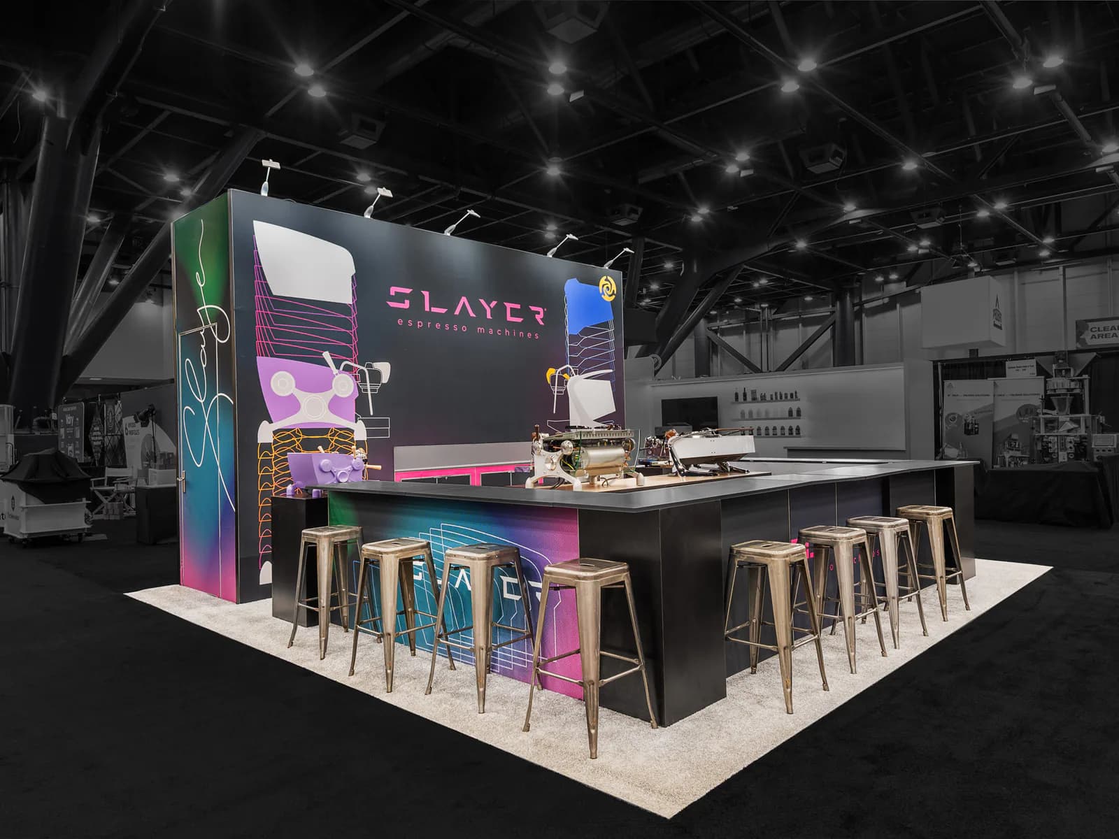 Black-and-white café exhibit with a central counter and colorful graphic backdrop.